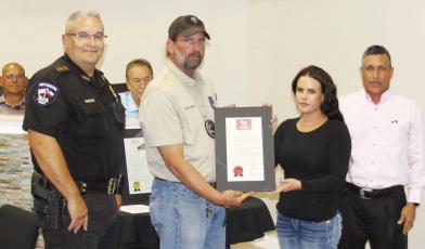 Chief Velasquez and Mayor Casias present the National Animal Control Officer recognition certificate.