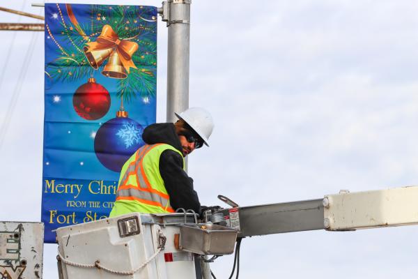 City work crews were out the day before Thanksgiving hanging Christmas decorations along Dickinson Blvd