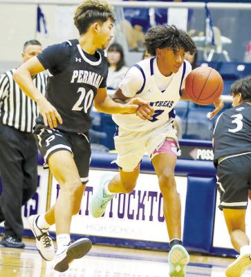 Evan Cordero (32) dribbles around a Permian defender on Dec. 19. Cordero scored 16 points to lead Fort Stockton in a 108-50 loss. Photos by Shawn Yorks