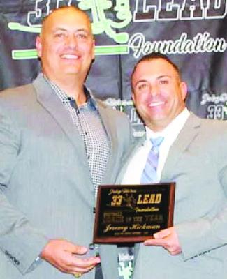 Coach Jeremy Hickman, left, with Joe Flores, founder of the Joby Flores “33 Lead” Foundation.