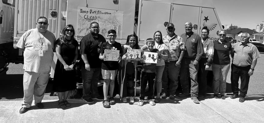 Ezra Quiroz, Bella Amaro, and Cato May pose with staff members from the City of Fort Stockton and their principal after being awarded the top three spots in this year’s Keep Historic Fort Stockton Beautiful art contest. Courtesy Photo