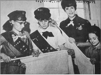 March 1968: GIRL SCOUT WEEK – These four young ladies represent the four levels of Girl Scouting. Here they replace curtains in the Girl Scout Hut on Texas Street after a clean-up and paint-up effort to prepare for Girl Scout Week, March 10-16. Th girls are, from left, Junior Scout Linda Smetak, Cadet Scout Pamela Eaton, Senior Scout Mitzi Stumpf and Brownie Scout Marsha McKenzie.