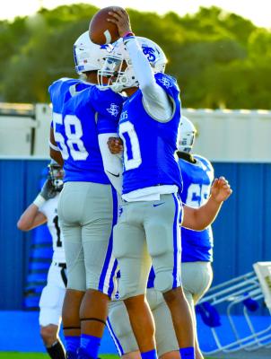 Marco Garcia (10) celebrates a touchdown with Aundre Washington (58) in this Sept. 8 file photo. Garcia completed six passes for 168 yards and three touchdowns and rushed for another 101 yards as Fort Stockton won its opening District 3-4A game of the season, 5421, at Clint last Friday night. File photo by Julie Myers