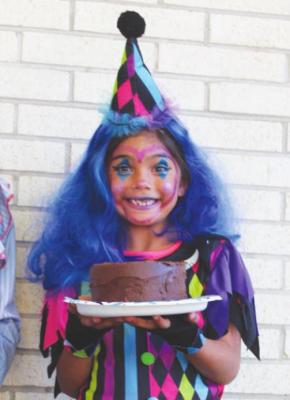 One of the most popular costumes this Halloween in Fort Stockton is of a clown. As the winner of the costume contest, this colorful clown holds her chocolate cake prize with pure joy.