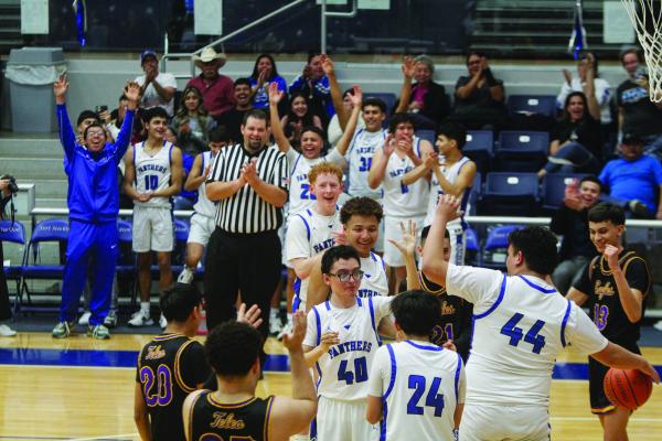 Fort Stockton’s Dylan Alvarado (40) is congratulated by his teammates and the Pecos players following his two-point basket to begin the third quarter during the teams matchup on Feb. 15 at the Special Events Center. Photo by Nathan Heuer