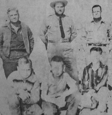 March 1959: SQUINTING in advance from the coming flash bulb glare, Joe Pilgrim (center) poses seated on top of the well he was trapped in for a few tortuous minutes. Also shown are two boys, Johnny Black and Jimmy Chambers, who got help for Joe. In the rear are three of several men involved in his rescue, Woody McDougald, officer Stanley Harrison and Roy Lannom.