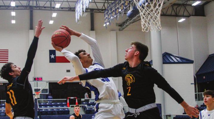Fort Stockton’s Ethan Acosta attacks the basket near the start of Tuesday’s game in Fort Stockton while Seminole’s River Powers (11) attempts to block the shot from behind. Photo by Nathan Heuer