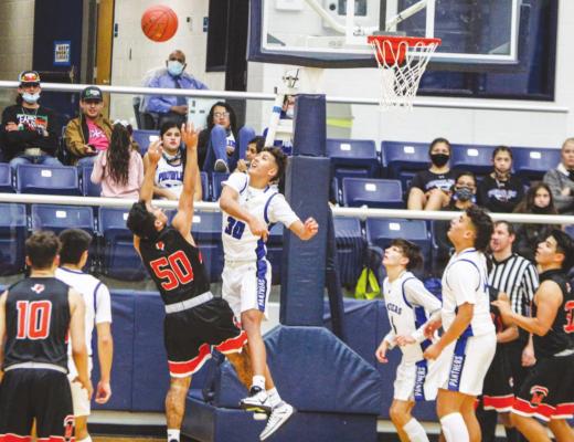 Fort Stockton’s Ethan Acosta (30) blocks a shot during the second half of Tuesday’s home game against McCamey. (Photo by Nathan Heuer)