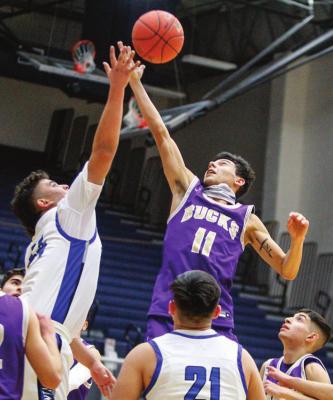 Fort Stockton sophomore Cruz Rojas, left, skies for a rebound against Alpine’s Isaiah Nunez (11) during Friday’s game at the Special Event Center. Photo by Nathan Heuer