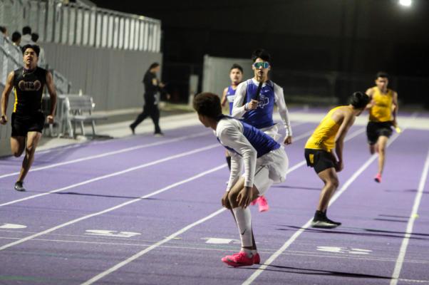 Fort Stockton senior Aryan Hernandez (googles) prepares to hand off to fellow senior Isaiah Garcia during the 800-meter relay at the West of the Pecos Relays on March 3. Photo by Nathan Heuer
