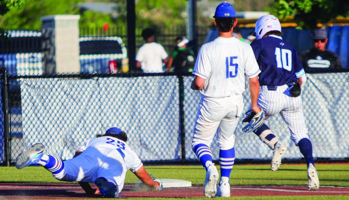 Fort Stockton’s Xzavier Dominguez (23) tags first base in time for an out, beating Greenwood’s Rance Purser (10) to the bag. Dominguez had one putout in the game with one opportunity, resulting in a perfect fielding percentage during the contest on the Panthers homefield on April 14. Photo by Nathan Heuer