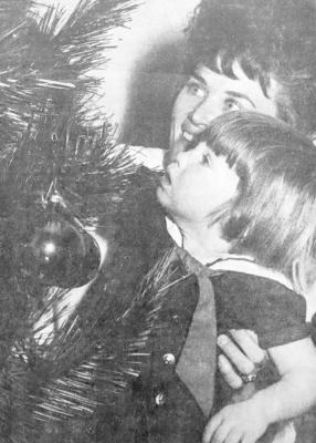 December 1969: HOLIDAY FEVER – Happiness and wonder take over as youngsters all over the city get familiar with the Christmas tree that has suddenly taken over the most important position in the house. Mrs. Ronald Dean and her daughter Deonna, who will be two years old on Tuesday, put the finishing touches on their tree at 1603 N. Colpitts.