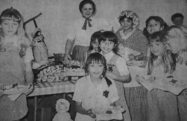 March 1986: CONFEDERATE TABLE – Judy Evans, leader of Brownie Troop 168 and helper, Isabel Villareal, are in costume representing early-day Texas women, as they served refreshments from a table decorated witj keepsakes from that time in history. Brownies made the cornbread squares which were served from the table.