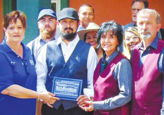 The Classic Man owner Avan Feyry was presented a Fort Stockton Chamber of Commerce official membership plaque by representatives of the Chamber of Commerce, Chamber Ambassadors, and Chamber Board of Directors on Friday at the business’ grand opening. Courtesy Photo
