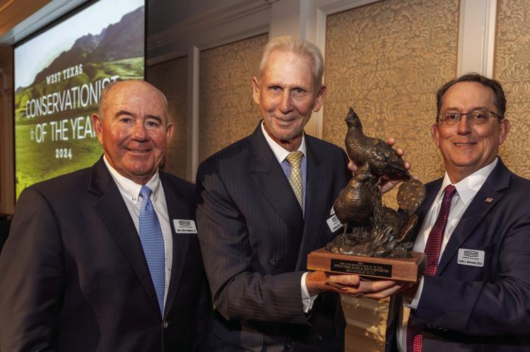 Presenting the award to Pointdexter (center) is BRI Advisory Board Chairman Dan Allen Hughes (left), and Director and founder of the Borderlands Research Institute, Dr. Louis Harveson.