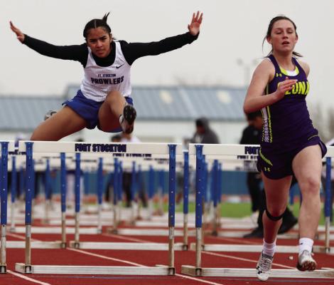 Melena Ramirez competes in the 100-meter hurdles alongside Ozona’s McKenna Luckie, Saturday in Fort Stockton. Photo by Shawn Yorks