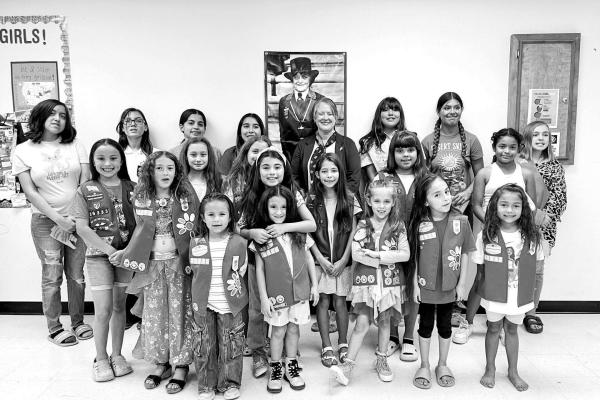 This week, the members of three Girl Scout troops gathered for Breast Cancer Awareness Month to learn about the disease and the founder of the Girl Scouts, Juliette Gordon Low. Pictured here with the young scouts is guest speaker Misty Mayo Frank, a former scout and leader, who shared about her own breast cancer journey. Photo by Crystal Beinhauer