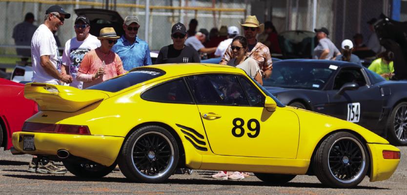 Racing fans check out the 1989 Porsche driven by Martin Hickman and navigator Scott Montrull shortly after the pair arrived back at Rooney Park after the race, Saturday afternoon. Photo by Shawn Yorks