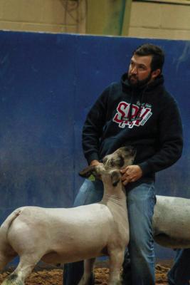 Pecos County Extension Agent Dalton York stands with his lamb during the West of the Pecos Blowout, where he highlighted the importance of giving young exhibitors a place to practice showmanship and gain valuable experience in West Texas.