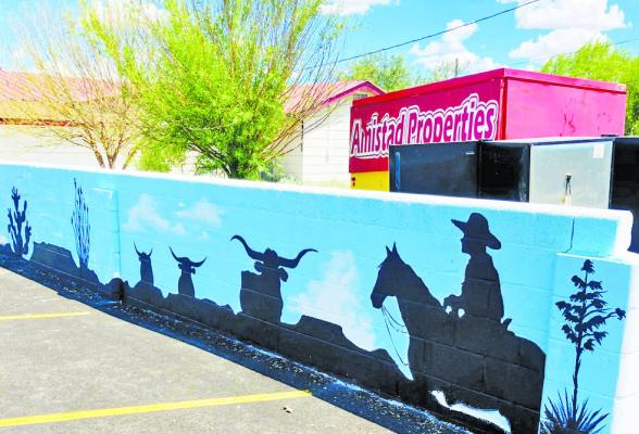 Artist Laurie Holman has begun painting a new mural behind Amistad Properties (Hacienda Square). The wall is still being painted and a second mural is in talks for downtown. Photo by Jeremy Gonzalez