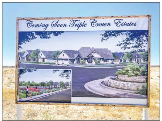 The Triple Crown Estates sign, which can found at the corner of Fifth Street and Greasewood Street, represents a view of what the subdivision could look like if developed in the future. The plans for the property will have to be put on hold for the time being as the annexation of the land did not pass by city council on Monday. Photo by Nathan Heuer