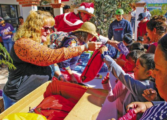 Fort Stockton High School teacher Collette Barragan hands out backpacks for school children on Dec. 24, 2022 in Boquillas del Carmen, Mexico. Barragan organized a toy drive for children and handed out backpacks in the border town adjacent to Big Bend National Park. Photo by Tristian Barragan