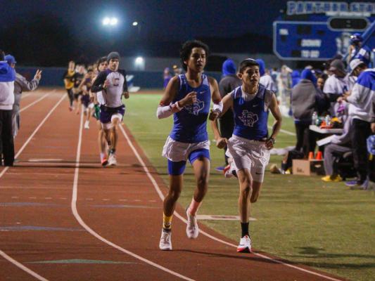 Fort Stockton mile runners Fabian Perez, left, and Juan Vela, right, led the 1,600-meter race during the Comanche Relays on Feb. 26. The pair ran side by side for the first three laps of the race. Photo by Nathan Heuer