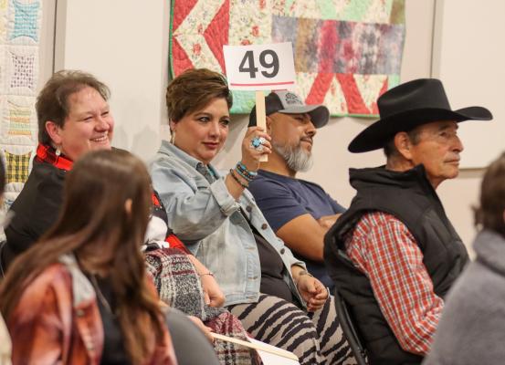 Bidder No. 49 at Thursday’s Xi Zeta Lambda sorority holiday auction. Photo by Shawn Yorks 