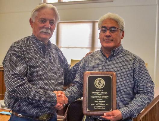 Pecos County Judge Joe Schuster, left, presented a plaque to Precinct 4 Commissioner Santiago Cantu Jr. for his 16 years of service as a county commissioner at the Dec. 27 commissioner’s court meeting. The meeting was Cantu’s last. Photo by Shawn Yorks 
