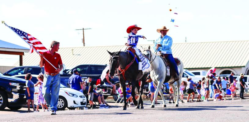 Miss Rodeo Comanche Springs Sweetheart, Loretta Rivera, throws candy to parade-goers during Sunday’s 4th of July parade on Main Street. Photo by Shawn Yorks