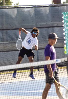 Panther player, Aric Palacios, leaps for an underhand return during a recent tennis match. Courtesy Photo