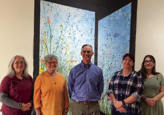 Steven Walker, middle, is pictured in front of one of his impressionistic paintings at his Chunkarts Studio &amp; Gallery, in Fort Stockton. From left to right: Penny Smith, FSCT Vice President; Alice Duerksen, FSCT President, Steven Walker, Renee Gaylor, SLAM President; Allie Sumner, SLAM Vice President. Courtesy