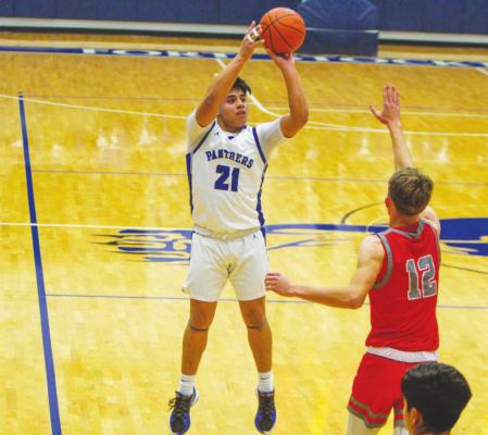 Fort Stockton senior Dominic Aguilar (21) releases a jumper on Dec. 14 in a home match against Denver City. Aguilar scored 20 points or more in two contests at last week’s Monahans tourney. Photo by Nathan Heuer