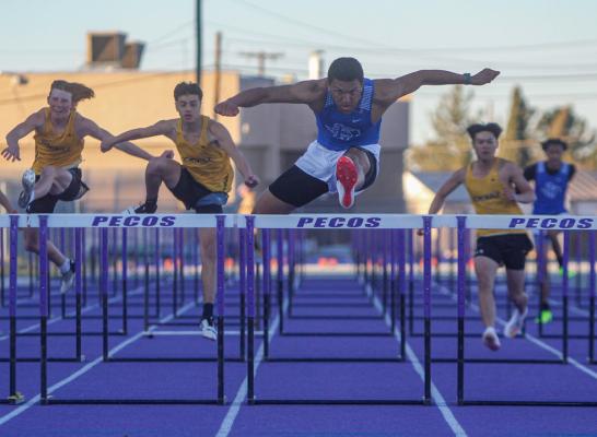 Zane Hodges hurdles his way to an easy victory in the 110 hurdles on March 3 in Pecos. The senior won the race by 1.72 seconds. Photo by Nathan Heuer
