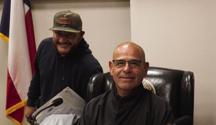 City councilmen Paul Jerome Chavez and Ruben J. Bernal smile after the recent council meeting where Chavez received recognition. Photo by Joh Covington