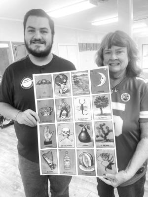 Andrew Franco and Diann Warnock hold up a large Loteria card. Courtesy Photo