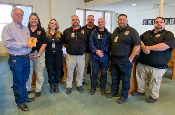 Pecos County Judge Joe Shuster, left, shows off a small plaque he receive from Pecos County EMS for his support of the local EMS over the 15 years since Pecos County took over the Fort Stockton EMS service. Shuster was joined by members of the Pecos County EMS. Photo by Shawn Yorks