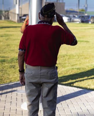 Veteran, Alonso Martinez saluting the US flag. Courtesy Photo by Zachary Gray.