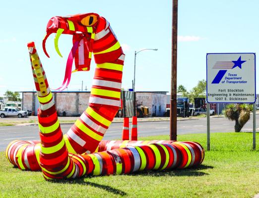 The TxDOT Engineering and Maintenance office at 1207 East Dickinson Blvd. has put out a large rattlesnake sculpture made entirely of warning traffic signs. The sculpture reminds drivers “Don’t Strike, Obey Warning Signs.” Photo by Shawn Yorks