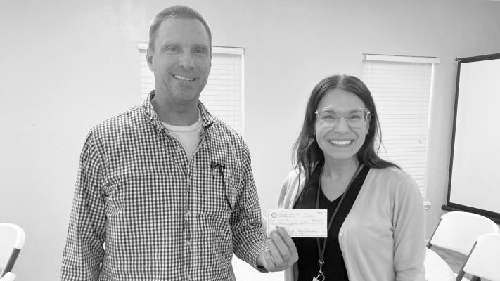Rotary Community Service Director Malissa Trevino presents Dale Briscoe with a check to cover aviation fuel for Angel Flights, a charitable organization that provides free flights for patients who require treatment in other cities. All flights take place in private planes, with the pilots donating their time and aircraft. Courtesy photo