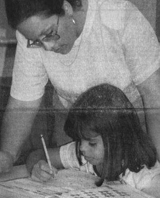 August 2000 issue: Gabryela Acosta, a second grader at Apache, gets a little help from her teacher Hortencia Aguilar with a math problem. Fort Stockton schools opened for the new year on Tuesday, August 15.