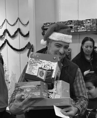 Senator Blanco helps distribute toys at the Toys for Tots outreach event. Courtesy Photo