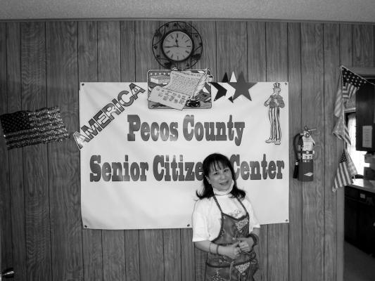 Mara Gilbert, director of the Pecos County Senior Center, gets ready to serve at a previous potluck.