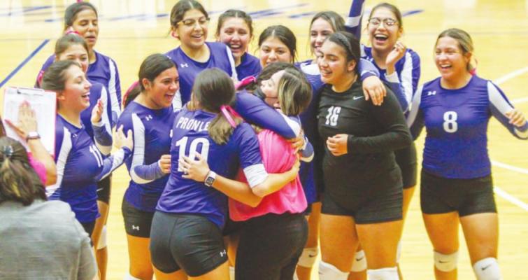 Fort Stockton first-year head volleyball coach Gabrielle Harral, pink, is hugged by her players after they won their first district match in five years on Tuesday at home. Photo by Nathan Heuer