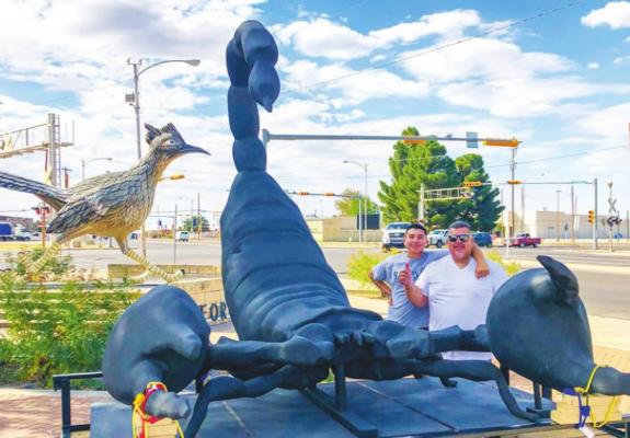Scotty the scorpion and Paisano Pete were side-by-side for a moment while Omar Martinez and his son Matthew stopped in Fort Stockton. Photo by Jeremy Gonzalez