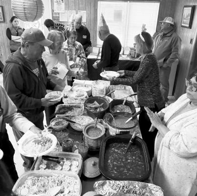 Seniors line up for dinner at a recent potluck. Courtesy Photo