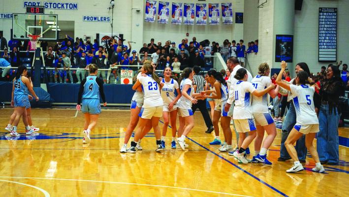 Fort Stockton Prowler players celebrate together on the court following their 50–48 victory over Greenwood on Thursday night. The win was sealed on a last-second basket, sending the home crowd into a frenzy. Photos by Karen Villanueva, Tumbleweed+