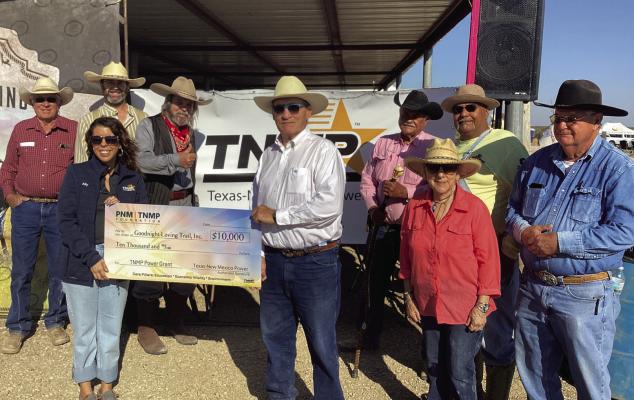 TNMP’s Ally Tello presents a $10,000 grant check to the Goodnight Loving Trail, Inc.