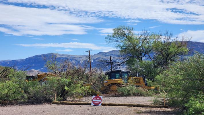 Heavy equipment rests silently on Sunday, August 16, after the border wall infrastructure began last week in Big Bend National Park. These machines were parked just past the turnoff to Cottonwood Campground, and the “new patrol road” essentially runs parallel to the already paved and maintained park road to Santa Elena Canyon. As of Sunday, the path runs from the parking lot at Santa Elena Canyon to this location. Photo by Kara Gerbert