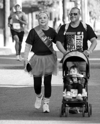 Lupe Munoz, a breast cancer survivor, and Joe Flores, walk with Lupe’s granddaughter in the stroller in last year’s Stronger Together Pink Out 5k. Courtesy Photo